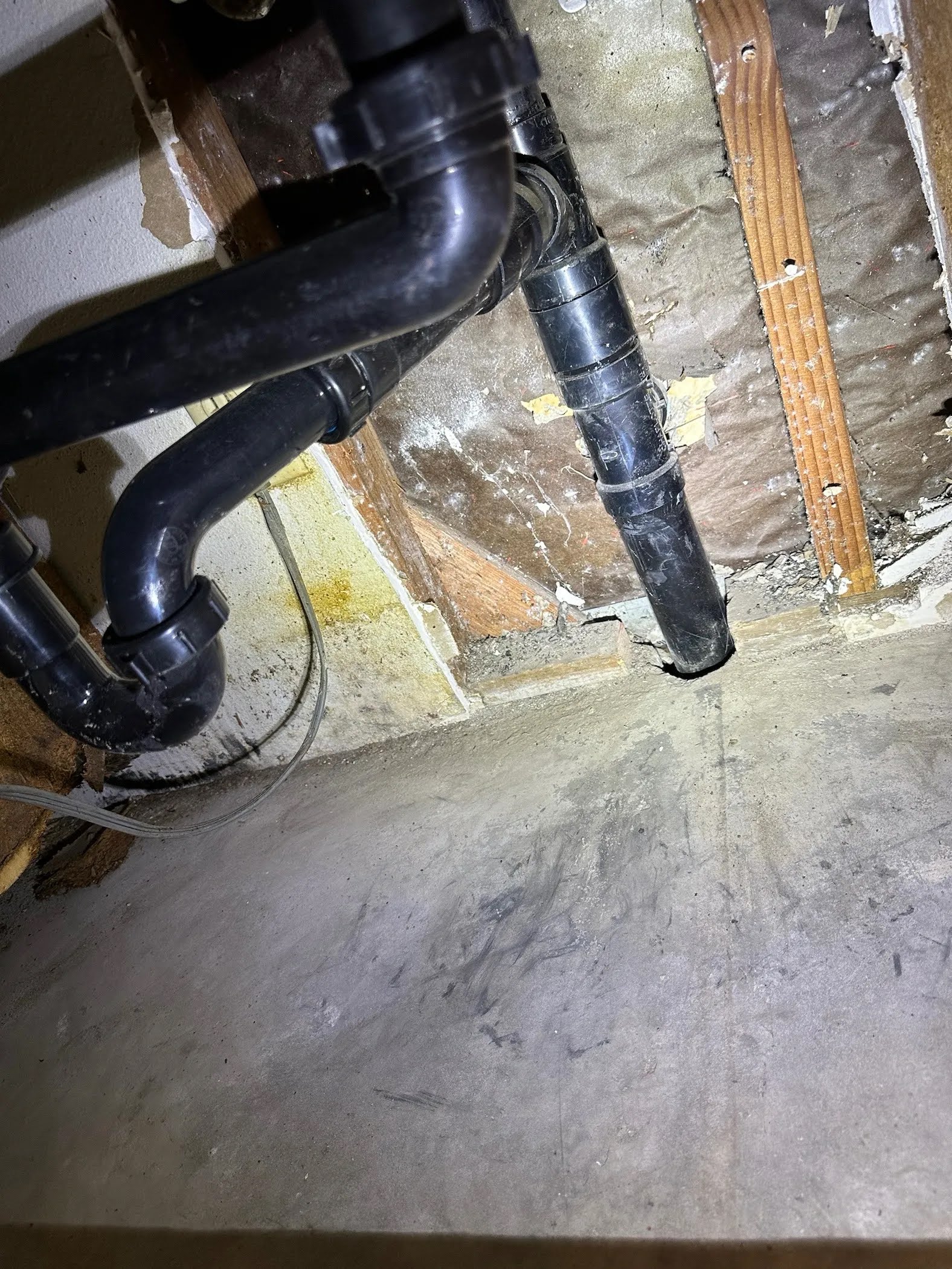 Kitchen drain piping connected to the repaired ABS line beneath the slab